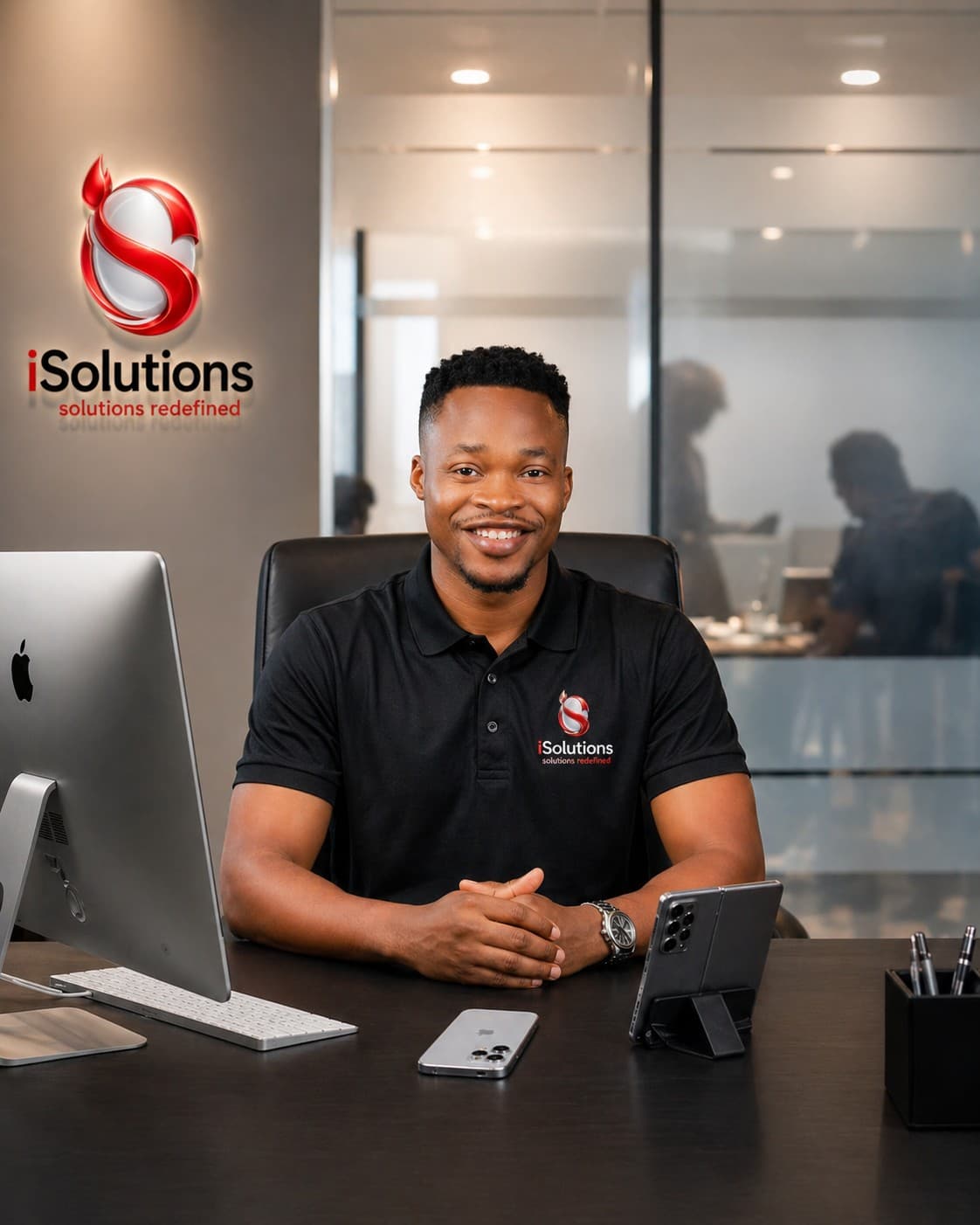 A young African tech professional working on a laptop